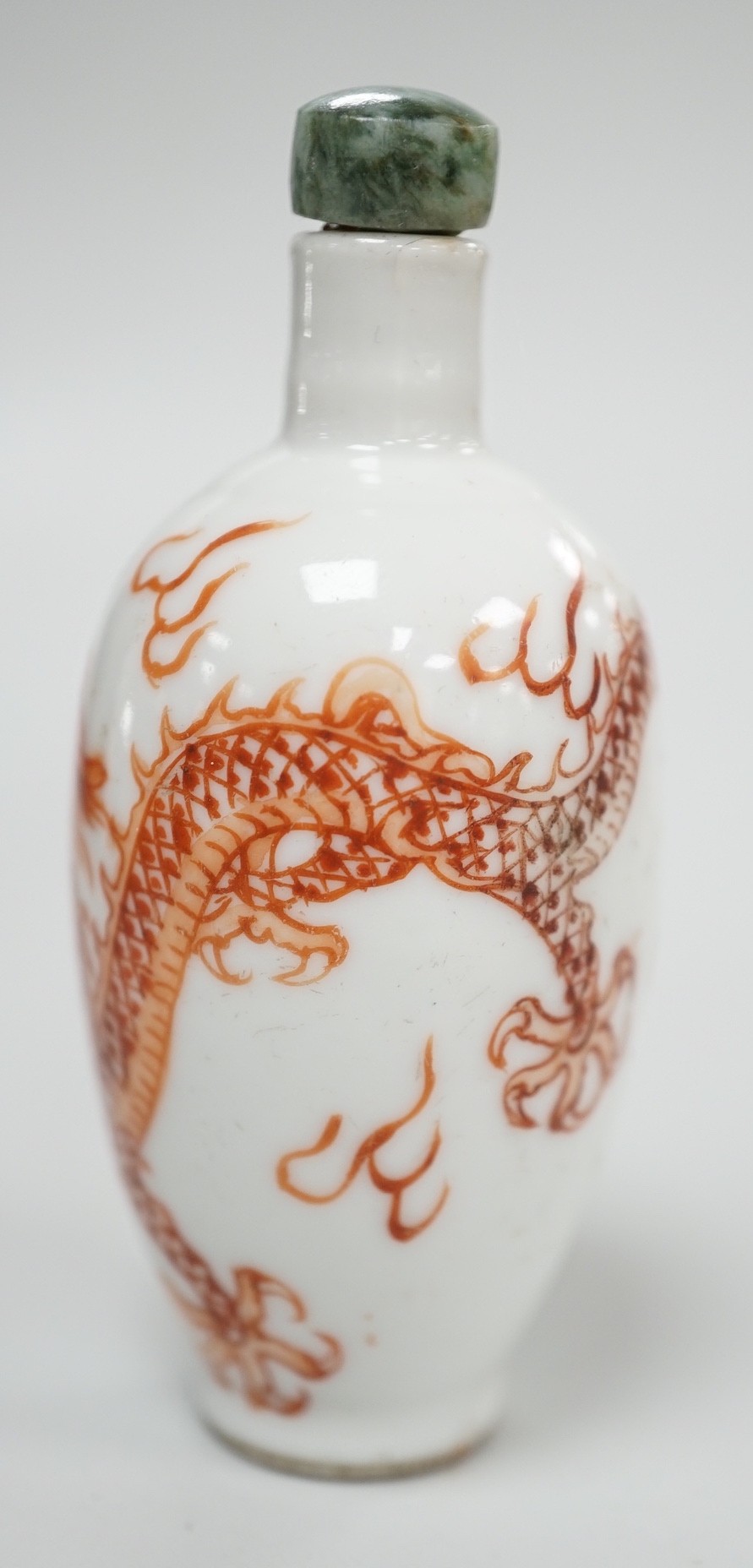 A Chinese rouge-de-fer 'dragon' snuff bottle, late 19th century, 6.7cm